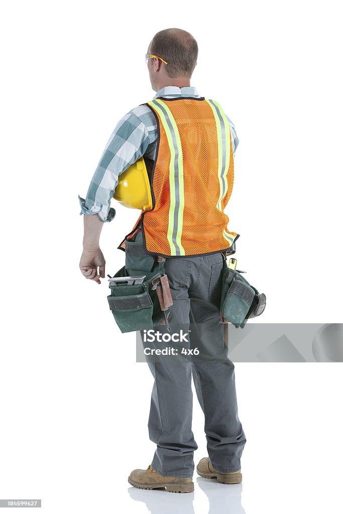 Vista posterior de un trabajador manual con casco duro - Foto de stock de Trabajador de construcción libre de derechos