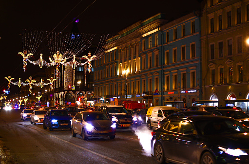 Russia, St. Petersburg - December 2, 2023: Car traffic along Nevsky Prospekt, decorated with New Year's decorations