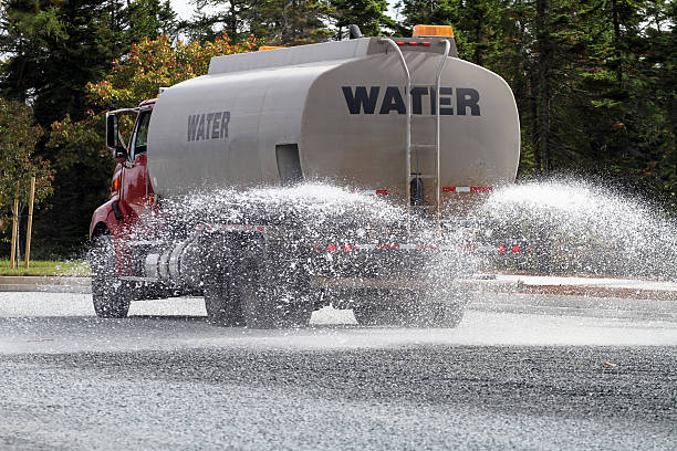 A Water truck spraying the street stock photo