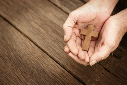 Wooden cross in hands