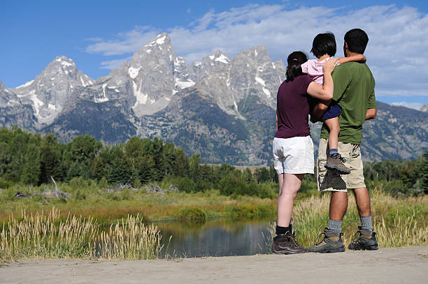 Family Of Hikers Looking at Mountains and River stock photo