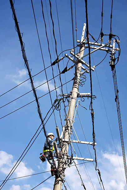 istock Electrician repairs a power line 184601394