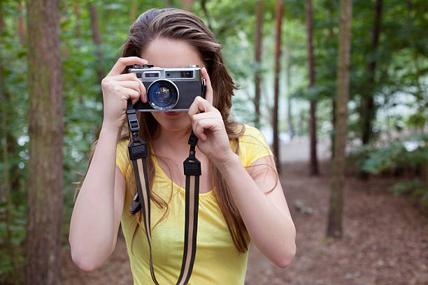 istock Young woman taking photos in the forest 184601408