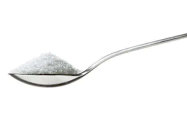 "sugar/salt on teaspoon, sideview isolated on white"