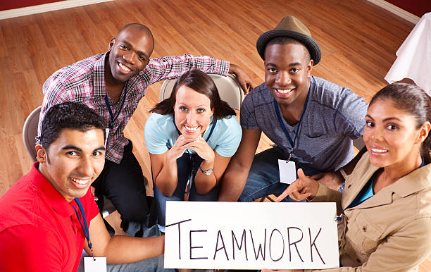 istock Mixed Ethnic Group of Young Adults with Teamwork Sign 184601639