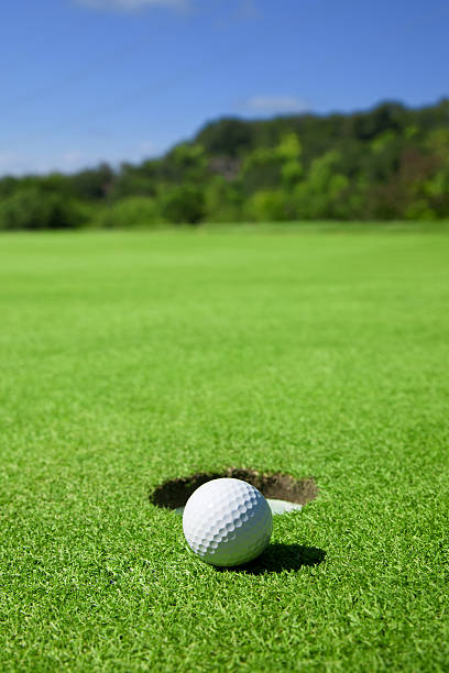 istock Golf Ball On Edge of Hole 184602324