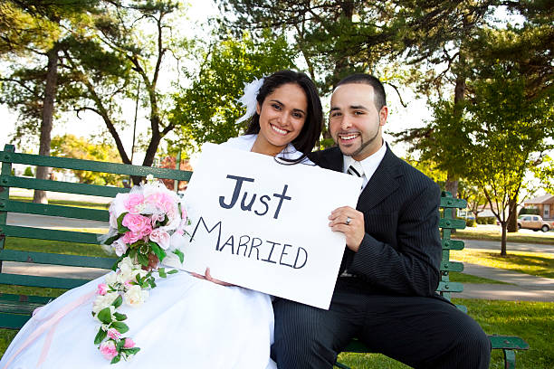 Bride and Groom outside with sign reading Just Married 