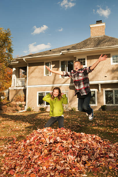istock Kids Having Fun in Outdoor Fall Leaves Clean-up 184602586
