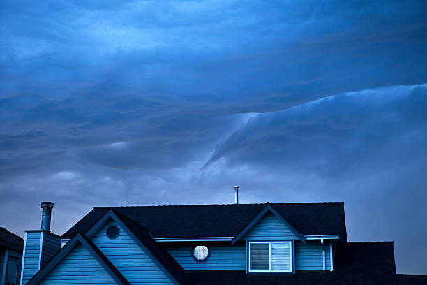 istock Top of a house and storm clouds with blue cast 184602590