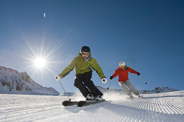 лыжница в действии с солнцем за - skiing close up sport colors стоковые фото и изображения