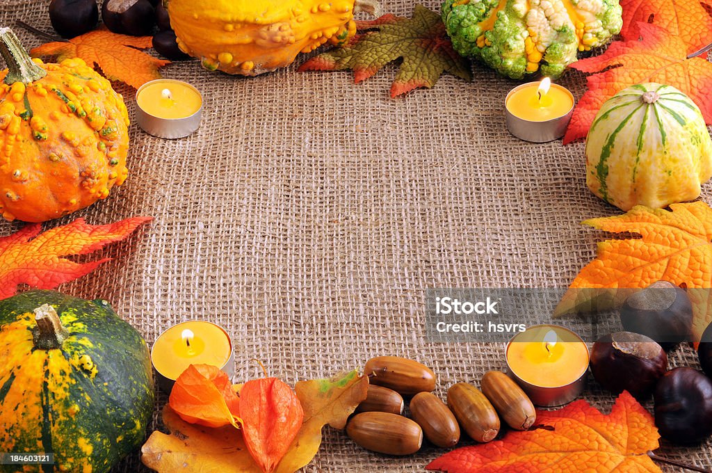 frame of pumpkins acron leaf tea light and copy space "Frame with Copy Space background, different version of pumpkins, tea lights, acron, oak leaf and chestnuts. Usefall for thanksgiving and halloween. Background burlap sack." Acorn Stock Photo