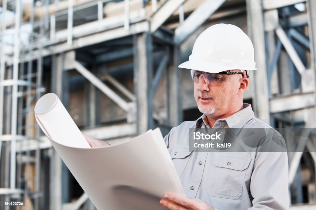 Ingenieur mit Bauarbeiterhelm lesen Pläne - Lizenzfrei 50-54 Jahre Stock-Foto