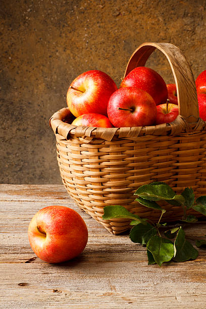istock Basket full of red apples on a wooden surface 184603852