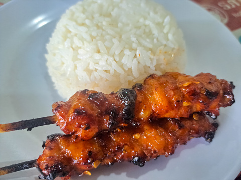 Chicken Satay Or Chicken Skin Satay With Red Spices And Rice On White Plate. Nasi Sate Ayam. Food Menu