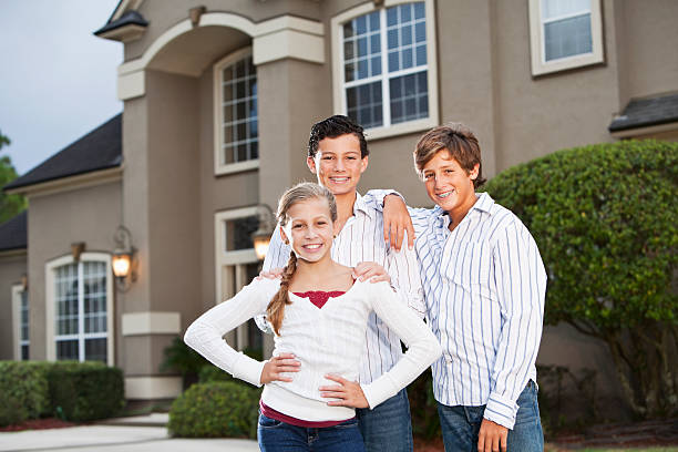 istock Family standing outside house 184604773