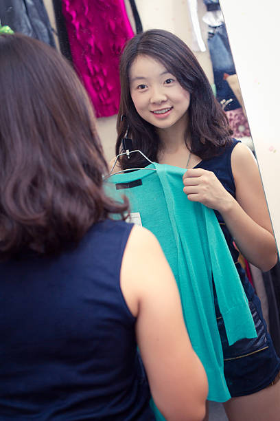istock woman trying on clothing 184605026