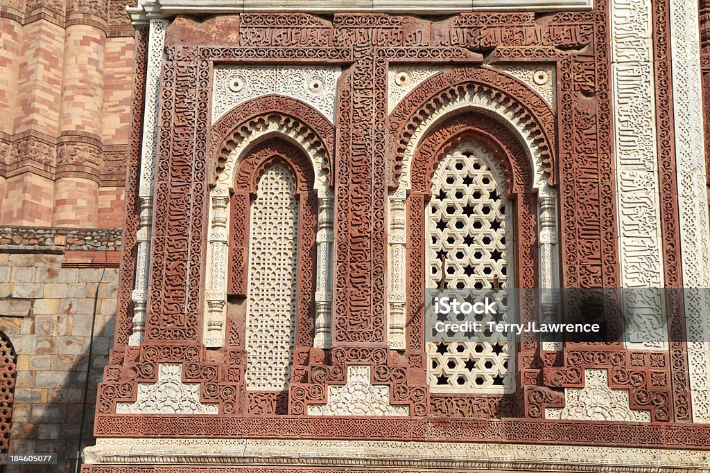 Quwwat-ul-Islam &#8216;Might of Islam&#8217; Mosque, Qutb Minar, Delhi, India "The Alai Darwaza gate of the Quwwat-ul-Islam (or aEMight of Islamaa) mosque, Qutb Minar complex, Delhi, India.  Work on the Quwwat-ul-Islam mosque began in 1193.  It was built by Qutb-ud-din Aibak (or Aybak) from the remains of 27 Hindu and Jain temples.  The mosque now forms part of Delhiaas Qutb Minar complex.  Built of red sandstone and faced partially with marble, the Alai Darwaza gate is covered with intricate carvings and verses from the Koran." Arch - Architectural Feature Stock Photo