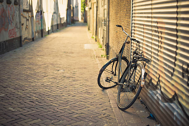 Old abandoned bicycle leaning on the wall in Delft, Netherlands. 