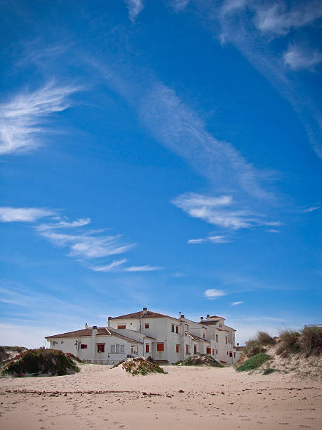 Arabic hotel buildings on a sunny beach. Sun, clouds and tropical scenery, background