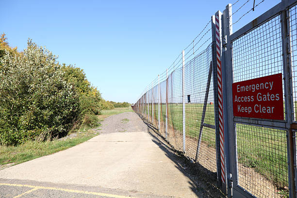 istock airfield perimeter security fence with warning sign 184605885