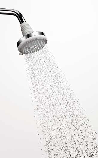Shower head with stop action water. Flash duration of 1/7000th of a second. You can see the bubbles in the water stream. One of a series.