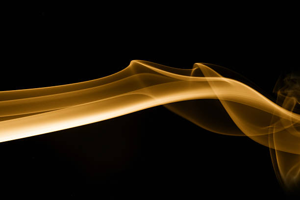 Close-up of incense smoke photographed against black background and then digitally tinted golden. Same series: