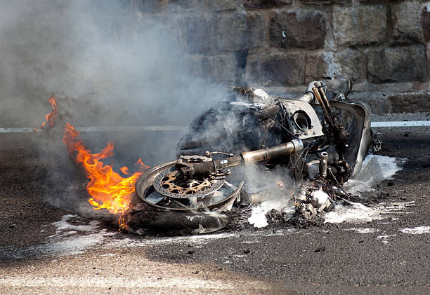 Burning motorcycle after bad accident stock photo