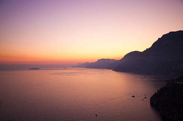 Amalfi Coast Amalfi Coast at dusk. Rocks of Capri visible in distance. praiano photos stock pictures, royalty-free photos & images