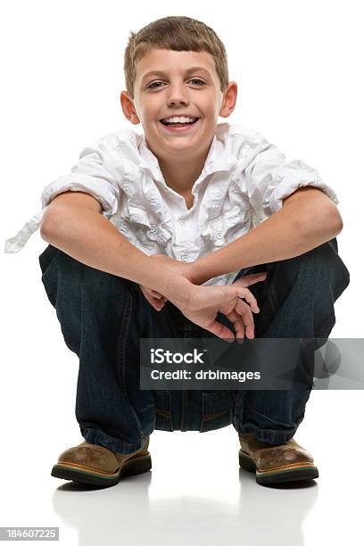 Happy Squatting Boy Stock Photo - Download Image Now - 8-9 Years, Blue, Boys