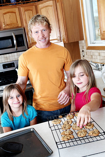 istock Father and daughter making cookies 184607372