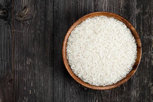 Photo of Rice in a wooden bowl