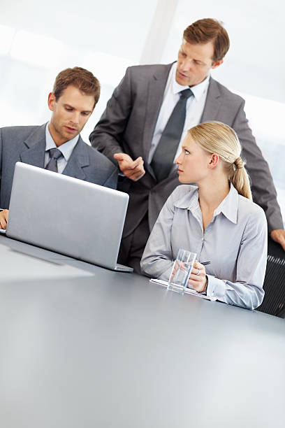 Business man and supporting team with laptop