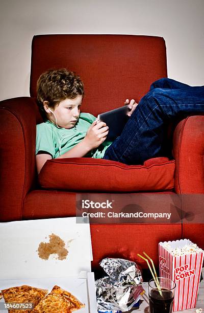 Couch Potato Boy Surrounded By Junk Food Playing Computer Game Stock Photo - Download Image Now