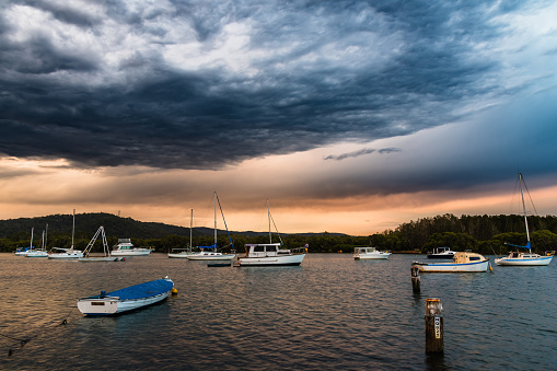 Sunset over the bay with storm clouds at Woy Woy on the Central Coast, NSW, Australia.