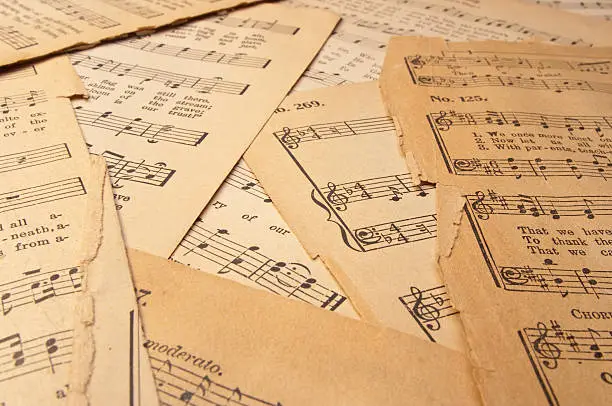 Old sheet music on parchment paper from an antique hymnal.  The printing is copyrighted 1890 and is in the public domain.