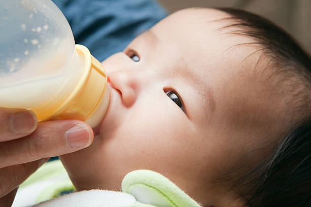 istock Asian Chinese Baby Feeding on Bottle CLose-up 184608269