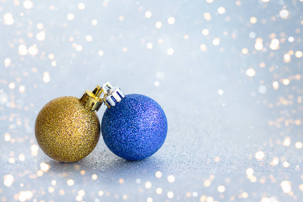 istock Christmas yellow and blue ball on shiny background with copy space 1846088223