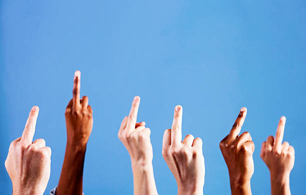 istock Six defiant hands making rude middle-finger gesture against blue background 184609039