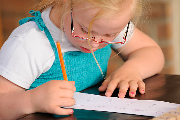 istock Girl with down syndrome is doing homework 184609040
