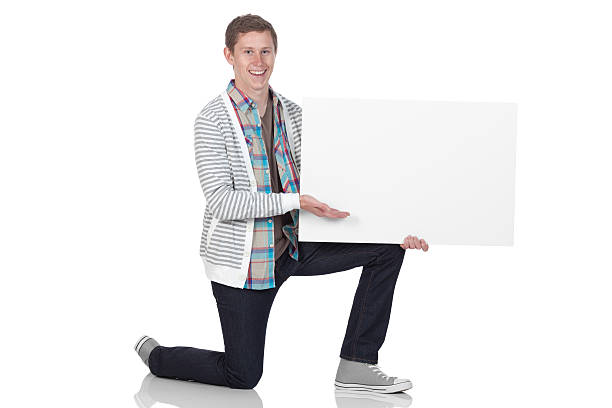 istock Man showing a placard and smiling 184609257