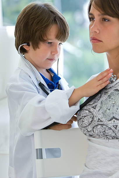 istock Little brother hearing big sister's heart 184609339