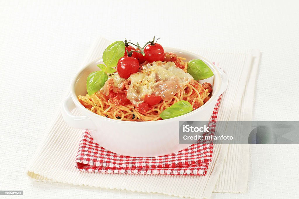 Bolognese spaghetti Spaghetti alla bolognese in a porcelain casserole dish Basil Stock Photo