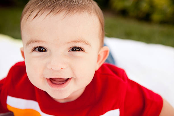istock Happy Baby Boy Leaning into Camera in Outdoor Setting 184609755