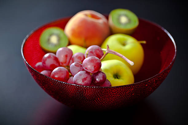 Vector image of an antique silver fruit dish with grapes, apples, pears, oranges and peaches.