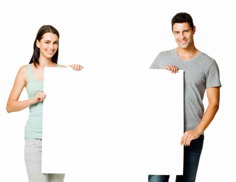 Attractive young couple hold up a blank sign with room for adding text. Horizontal shot. Isolated on white.