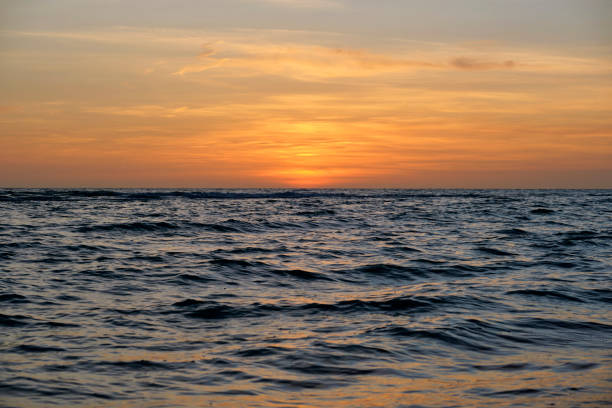 istock Dramatic red ocean waves at sunset with soft evening sea dark water 1846103572
