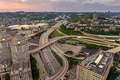 Cincinnati, Ohio transportation infrastructure. View from above of American big freeway intersection at sunset with fast moving cars.