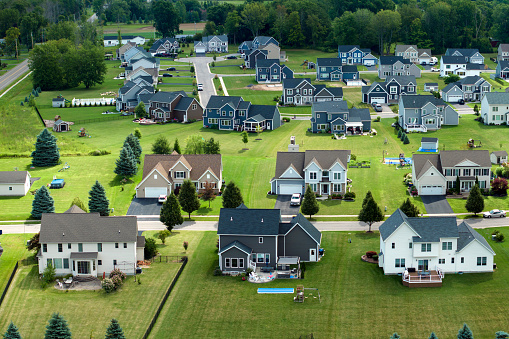 Aerial view of spacious new family houses in upstate New York suburban area. Real estate development in american suburbs.