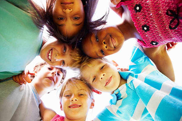 istock Multiracial kids huddling together 184610757