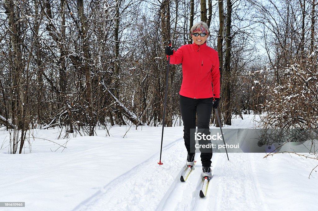 Smiling woman, cross-country skiing Happy woman skiing on a beautiful day. Cross-Country Skiing Stock Photo